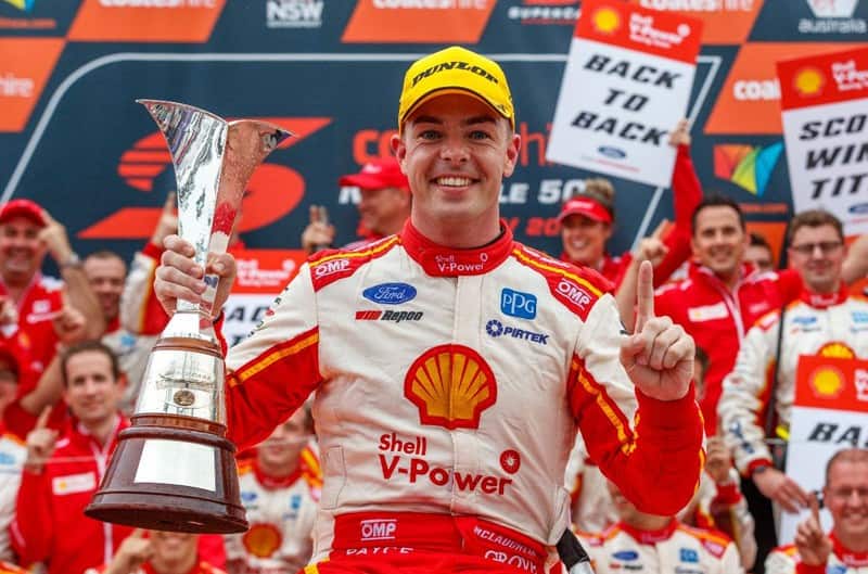 Scott McLaughlin holding his trophy while celebrating the championship